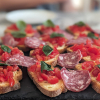 Bruschetta and salami on slate board